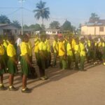 Students in yellow and green uniforms.