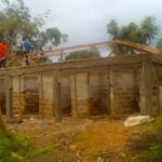 A man watches building construction.