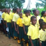 Group of children in yellow uniforms.