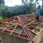 Man working on a new roof frame.